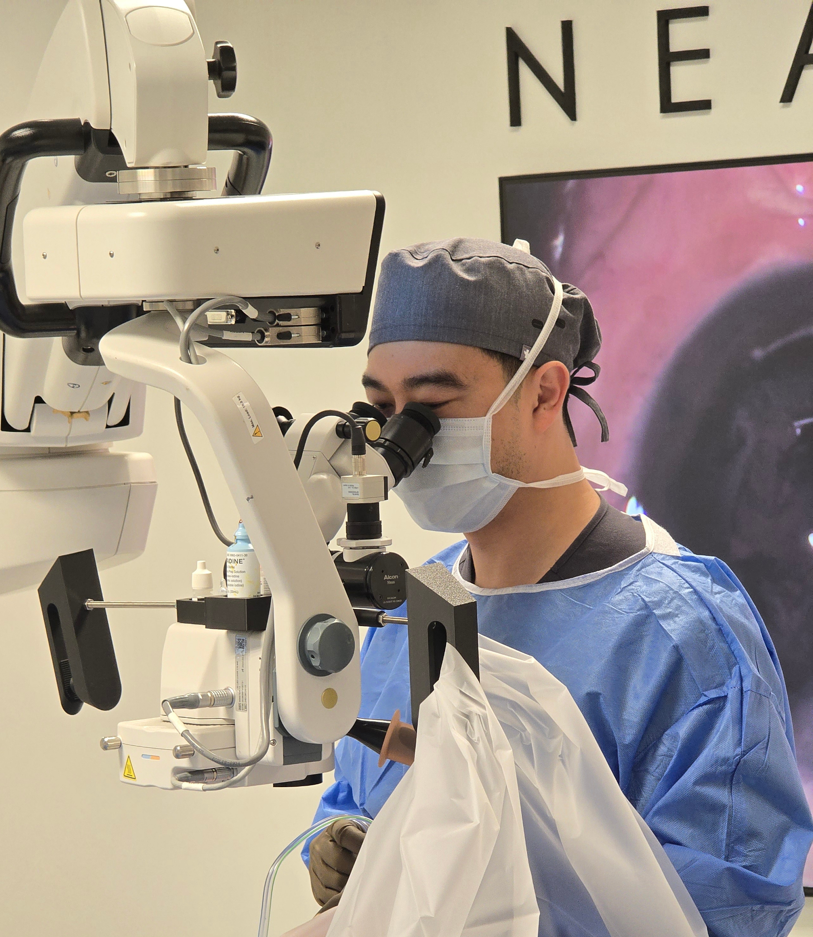 Dr. Jack Tian performing eye surgery at Near & Far Vision